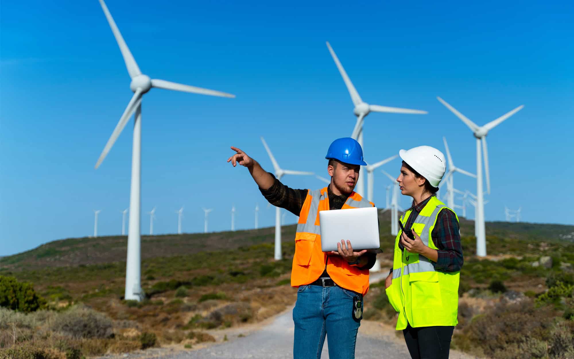 Wind Turbine Workers In Field With Tablet