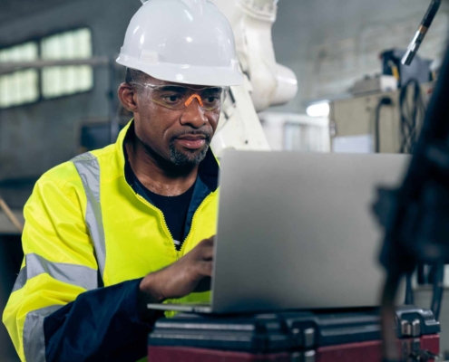 Factory Worker Checking Laptop